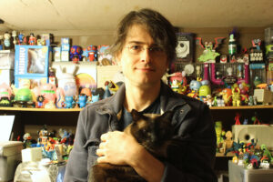 J.E. Moores with Shadow Cat and designer toy collection